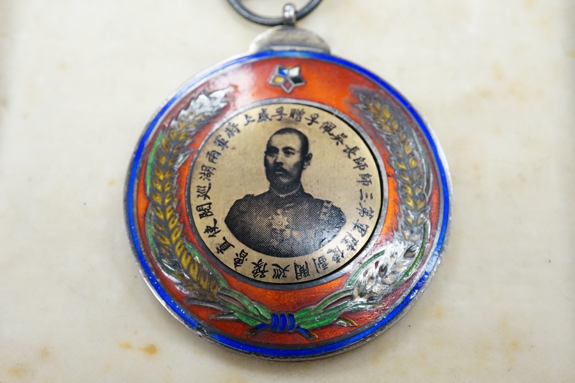 A Chinese Wu Pei Fu Sharpshooter enamelled medal, c.1915, with portrait of Wu Pei Fu to the obverse and crossed foliated rifles to the reverse, 40cm diameter